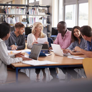 Group Of Mature College Students Collaborating On Project